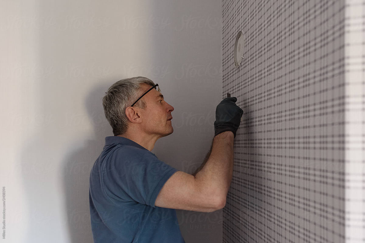 Man marking hole on wall to drill