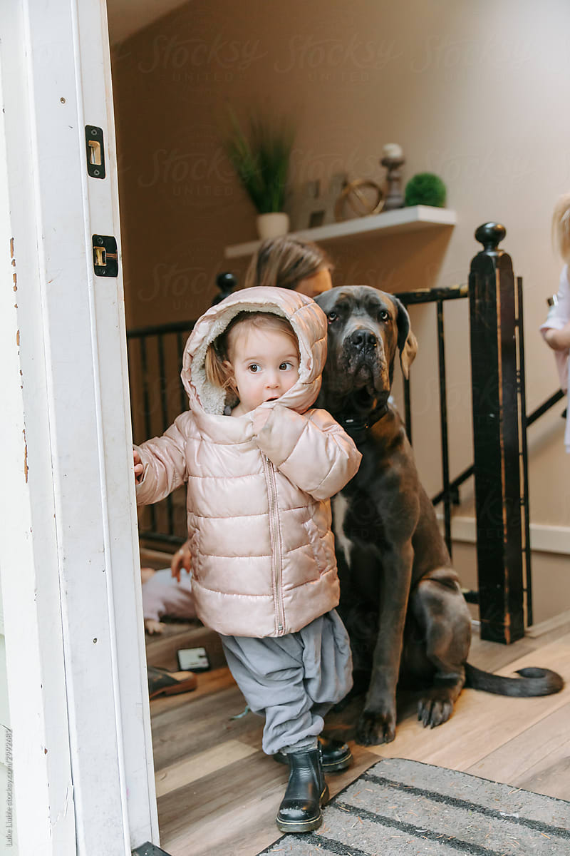 Young girl ready to go outside with dog