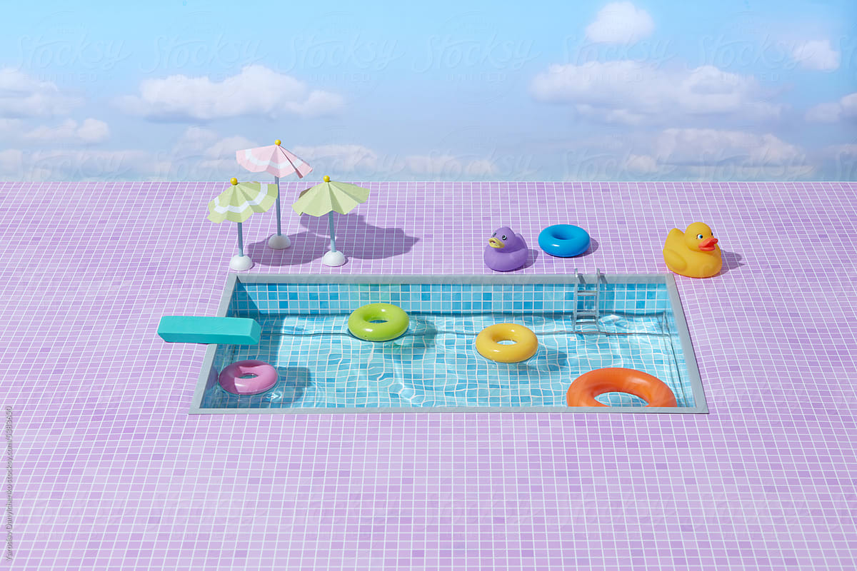 Pool with rubber ducks, ring floats and paper parasols.