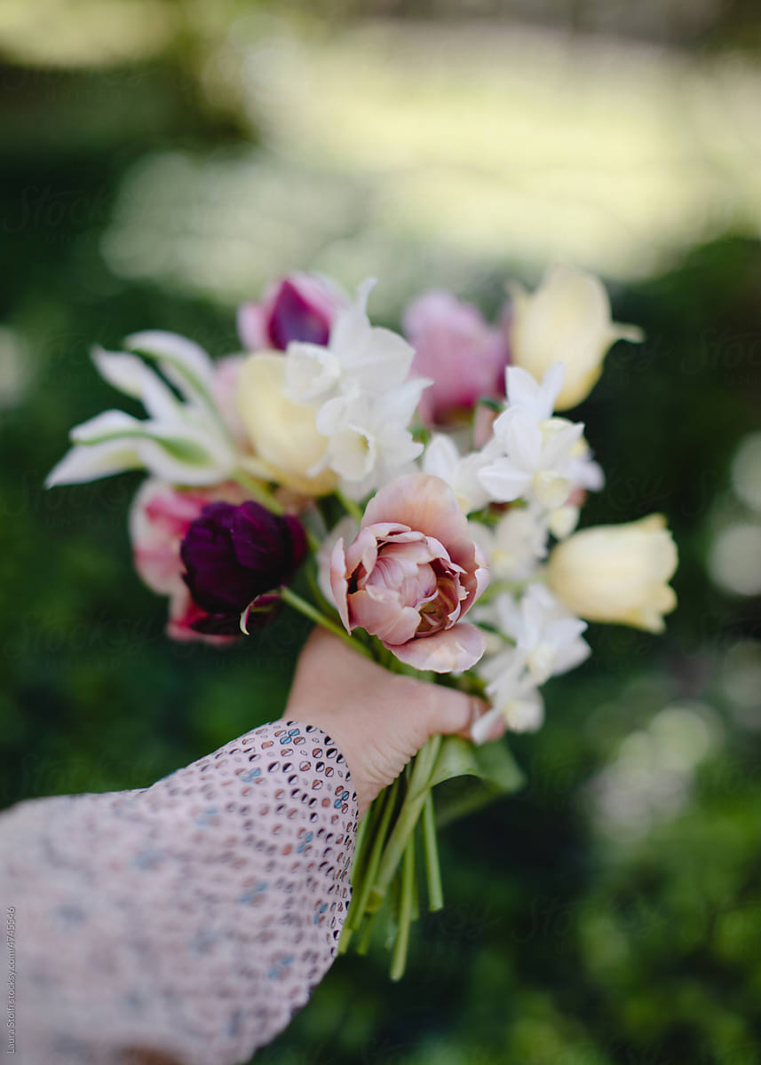 Fresh flowers in a bouquet in woman\'s hand