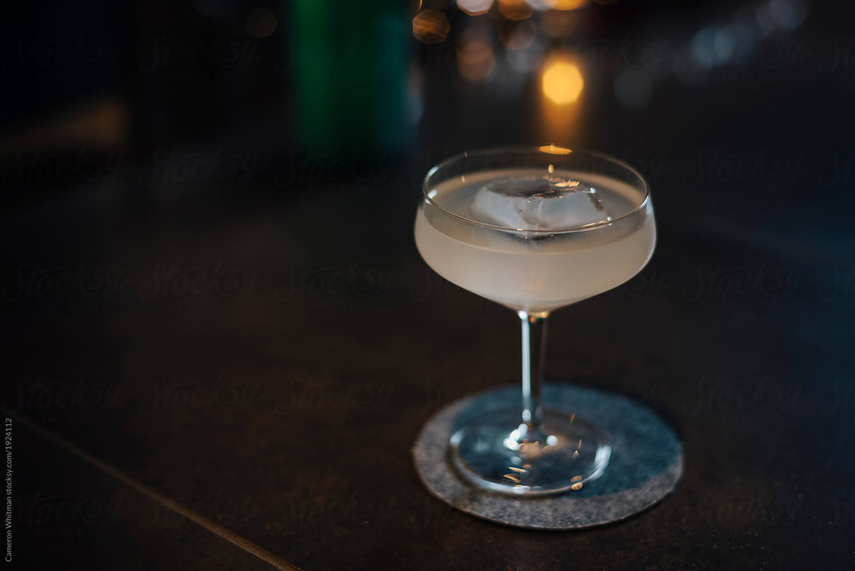 Gimlet cocktail in a dark moody bar setting