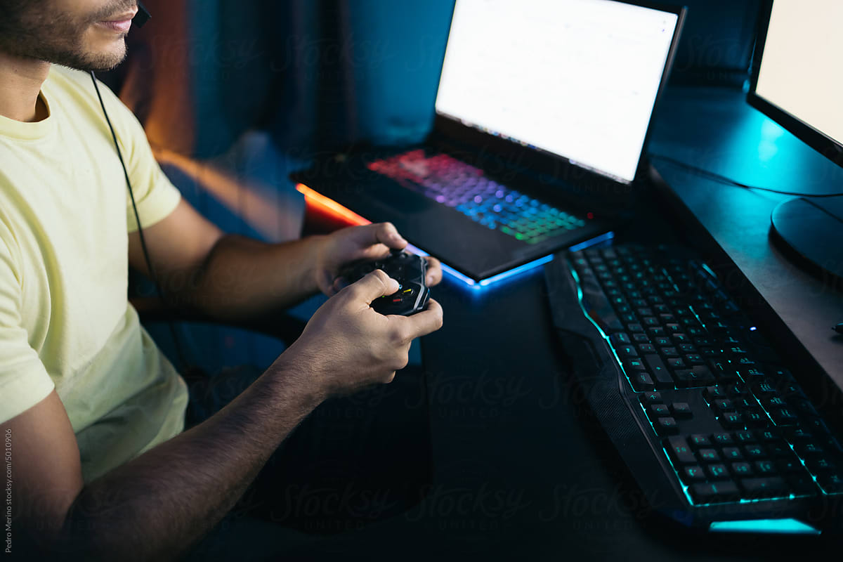 Close-up of a gamer playing video games on the computer