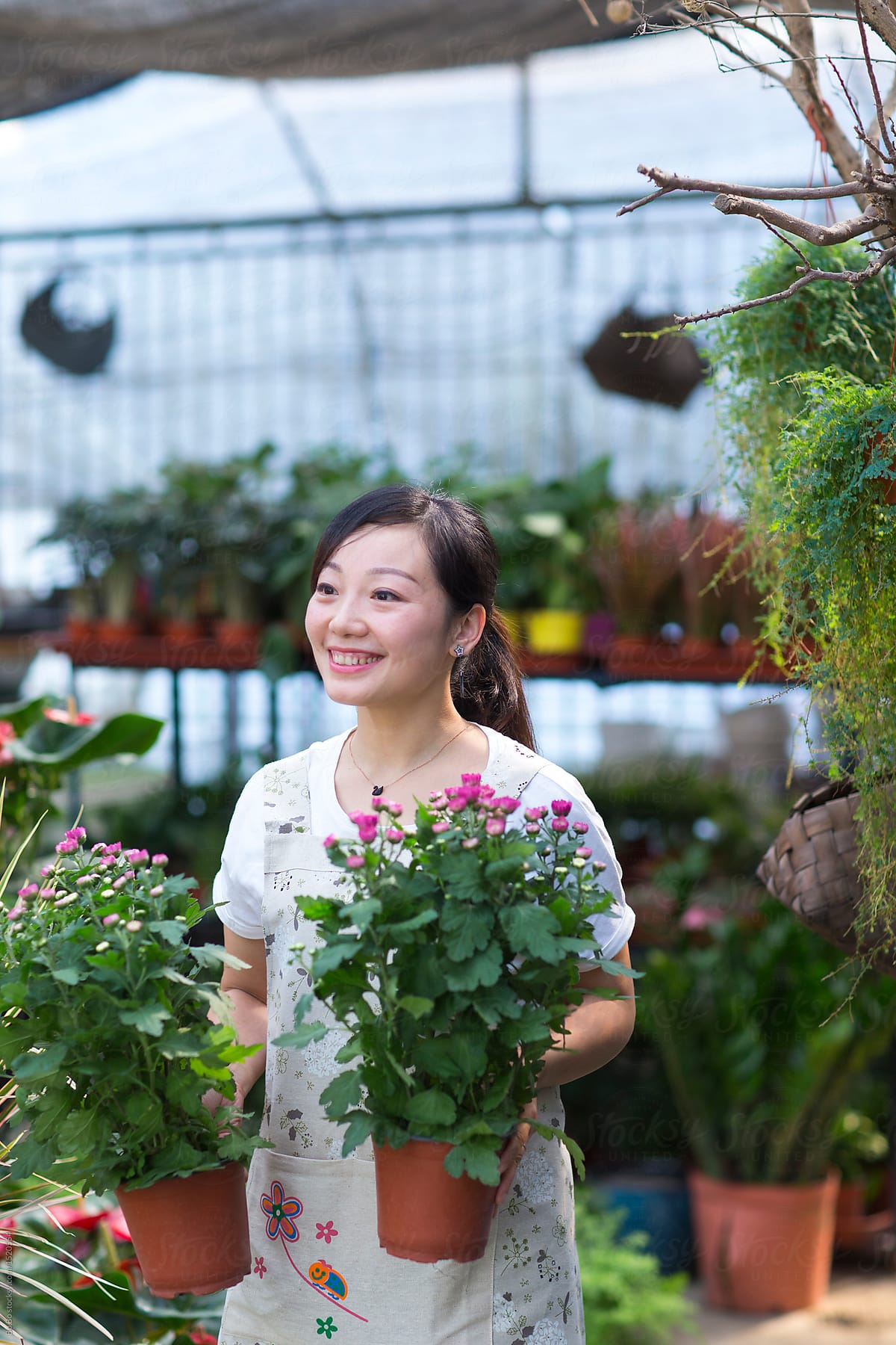 Female Asian florist working in the shop