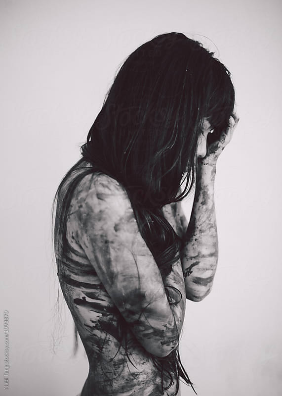 Black and white portrait photo of young beautiful Asian woman with messy paint on the body