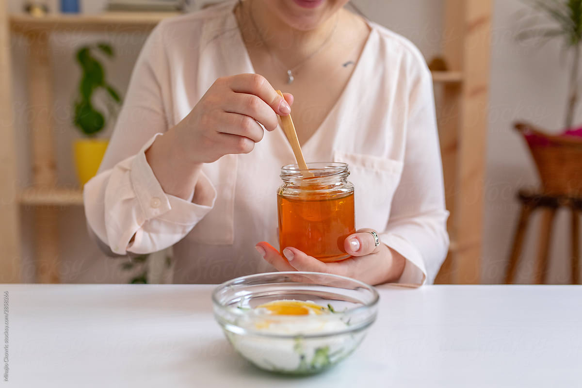 Young woman making a homemade face mask