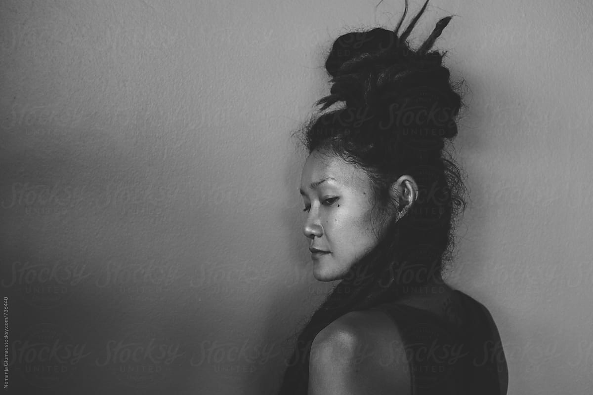 Authentic Thai Woman With Dreadlocks Looking Over Her Shoulder By Stocksy Contributor Nemanja