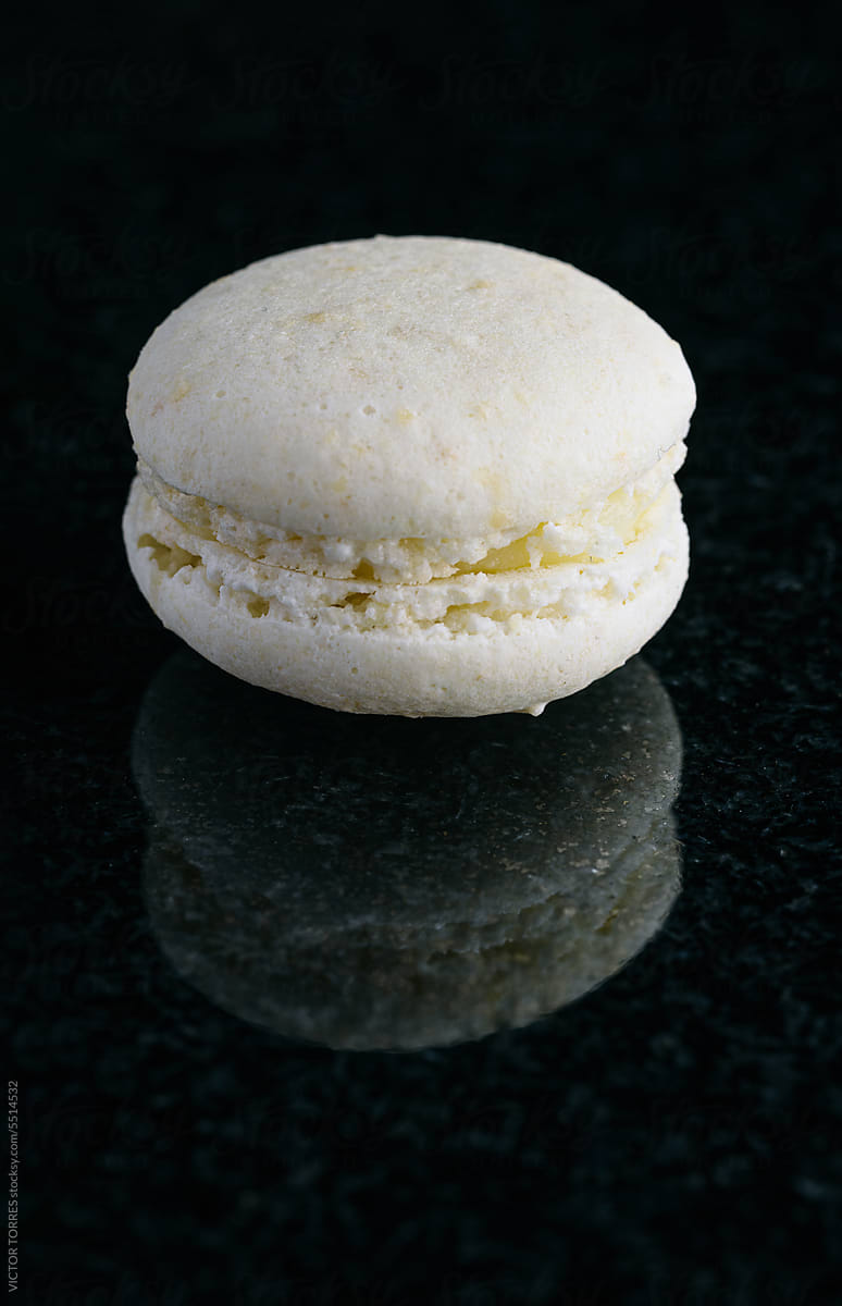 White macaron on black background