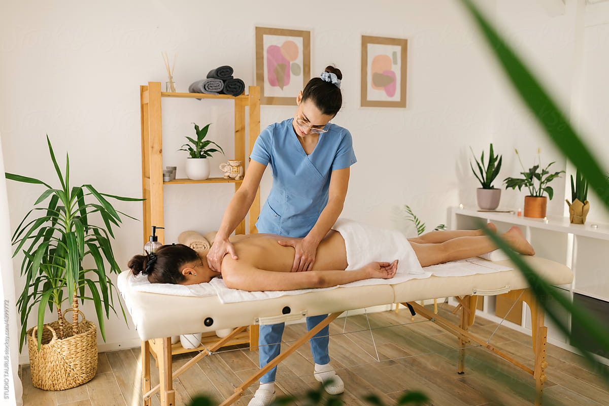 Woman having a massage at spa from therapist