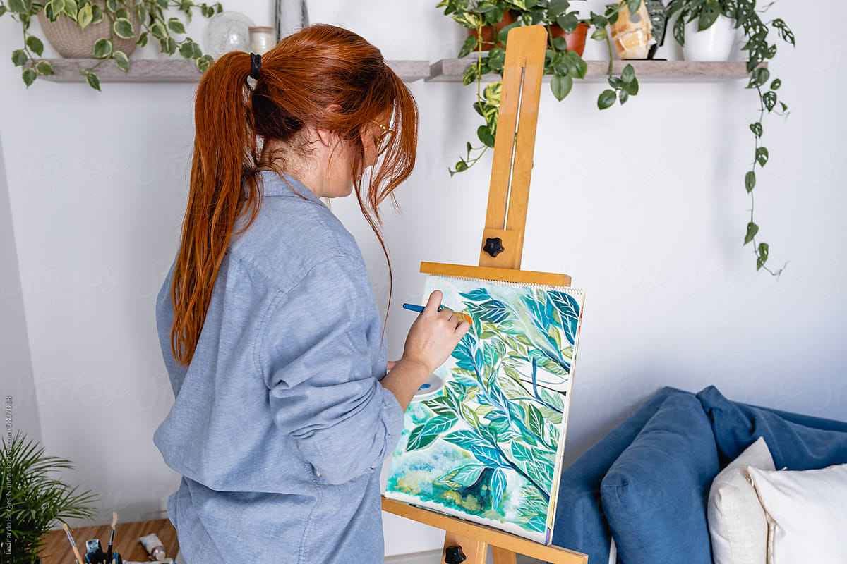 Woman painting on a canvas.