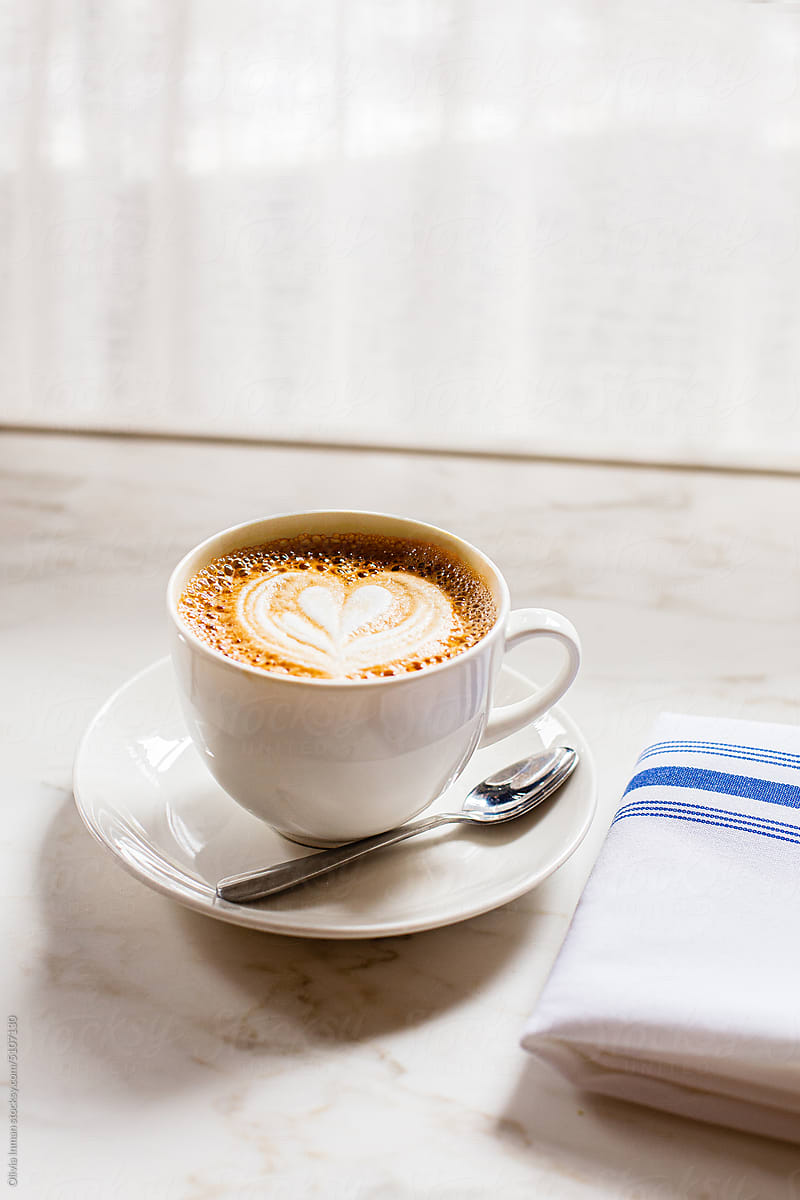 Latte in Teacup Near Cafe Window
