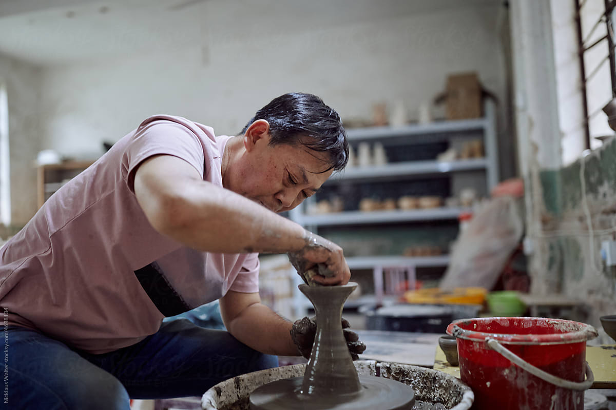 East Asian Small Business Owner Creates Pottery In His Workshop