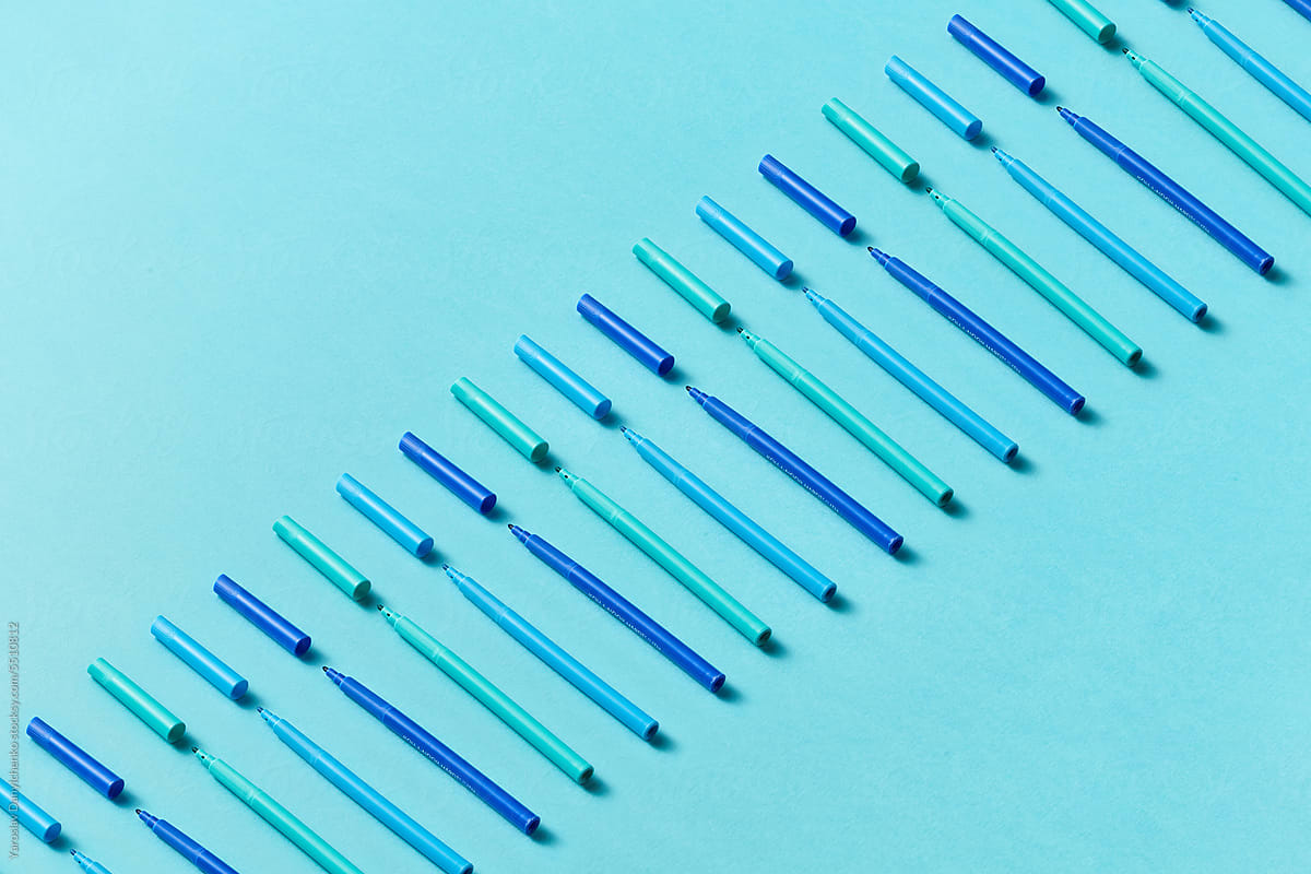 Minimal composition of blue colored markers in a line.