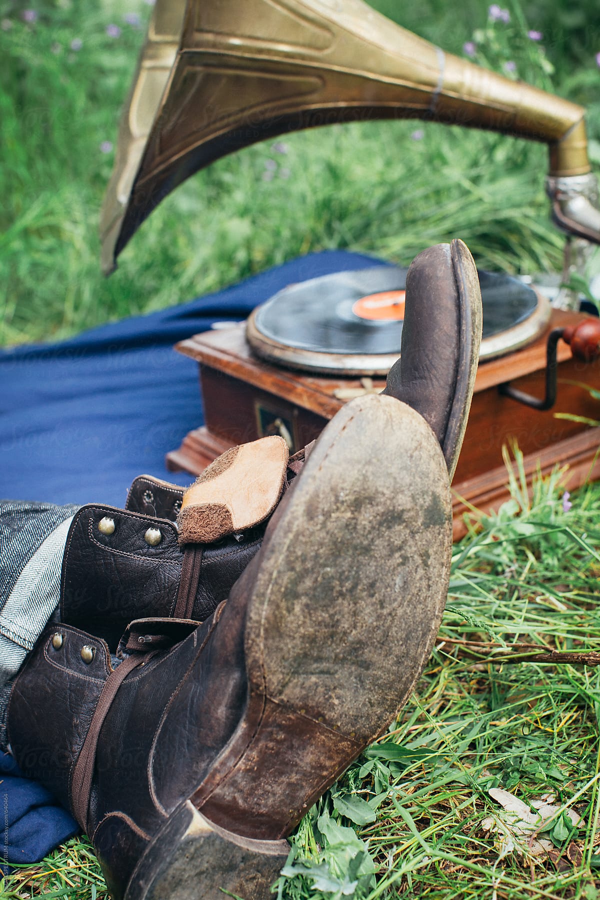 Close Up of Male Leather Boots and Gramophone