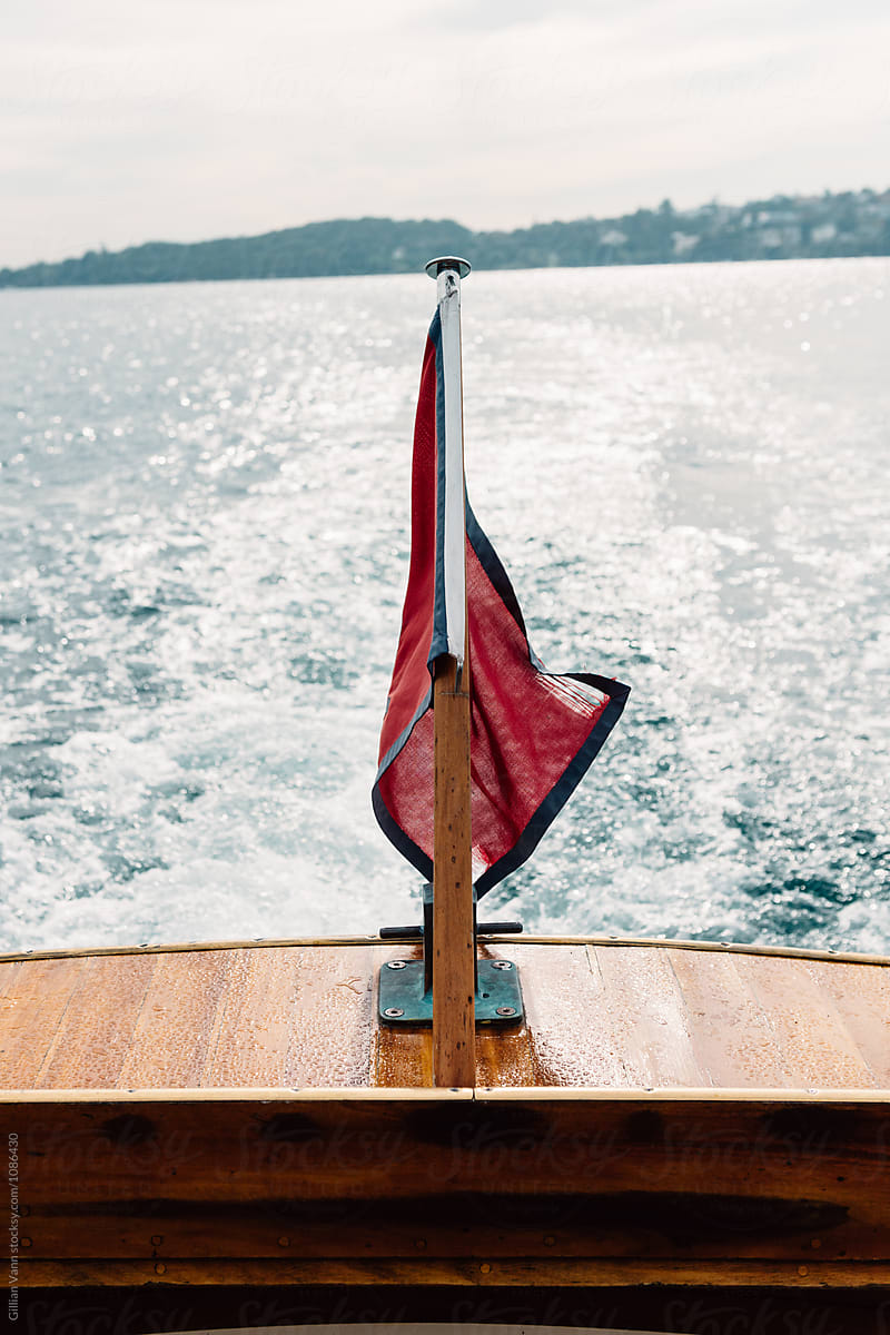 flag on the back of a timber yacht