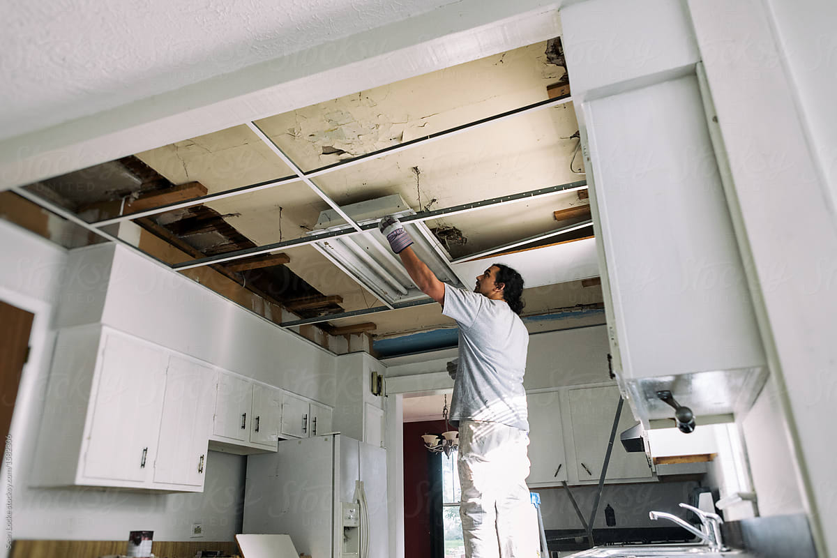 Kitchen Man Removing Support Struts For Drop Ceiling By Sean