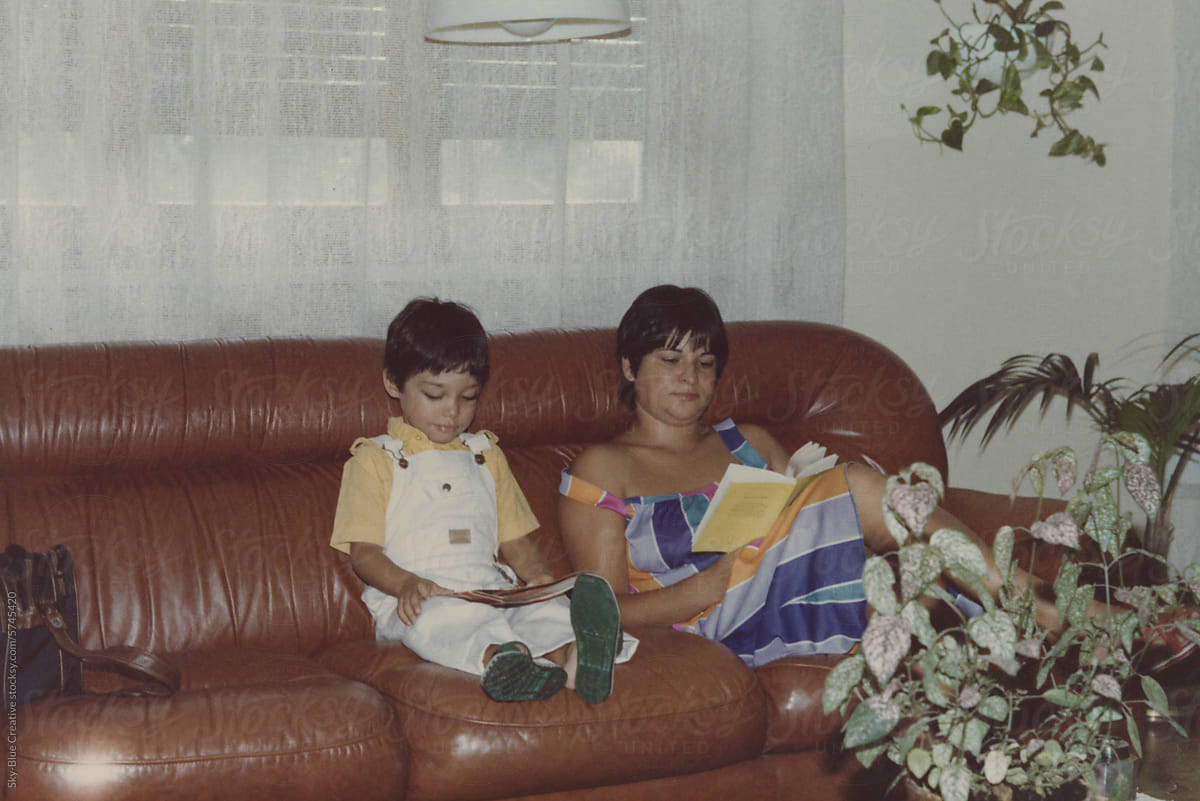 1983. Mother and son reading on the sofa