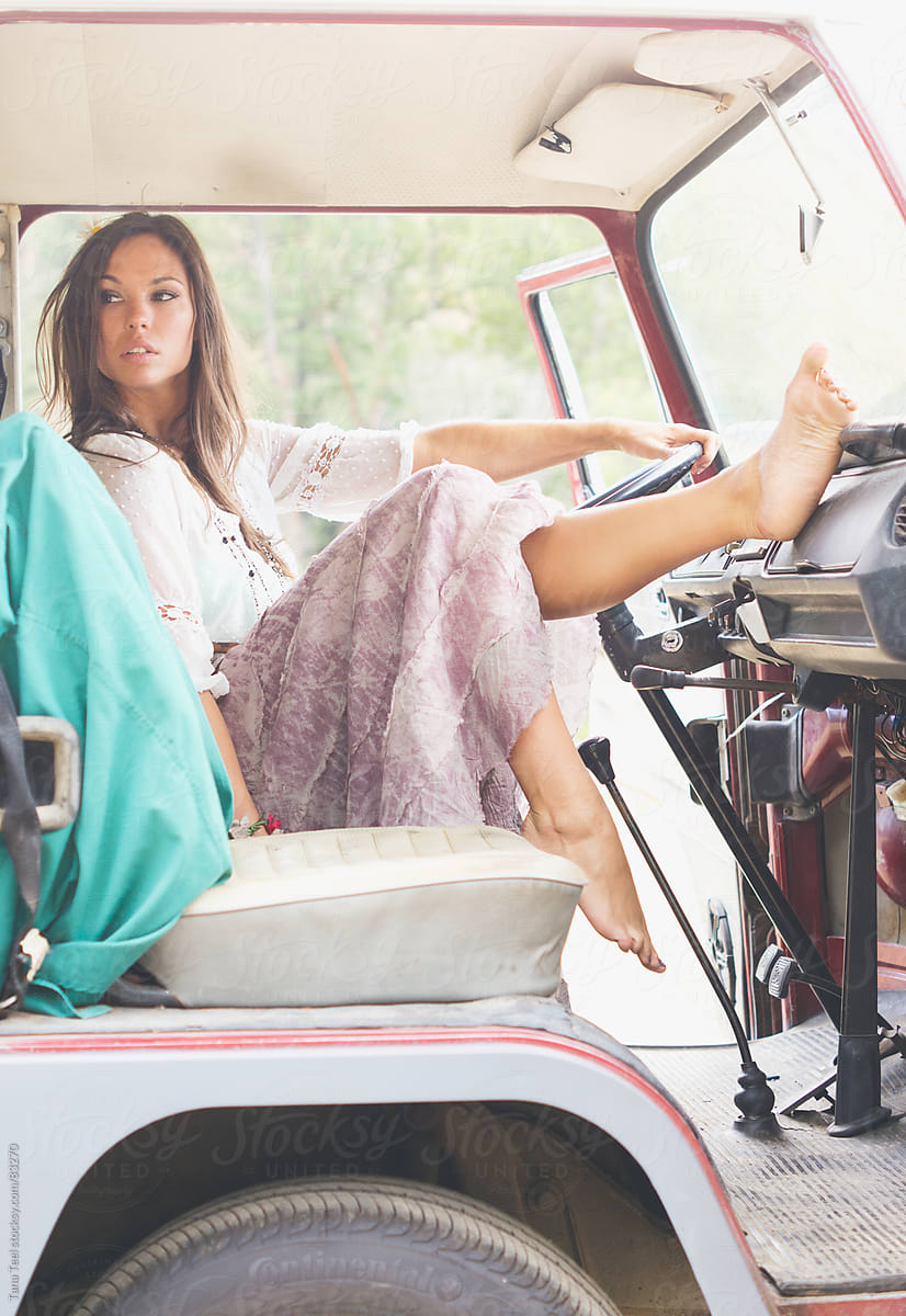 A Woman Dangles Her Bare Feet While Sitting In The Drivers Seat By