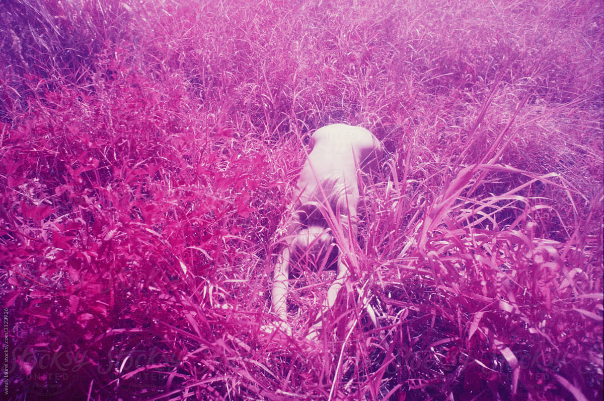 Pink infrared images of girl in a field grounding