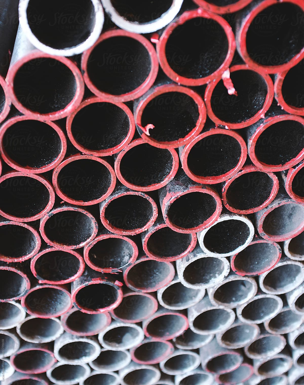 A bunch of metal pipes stacked neatly
