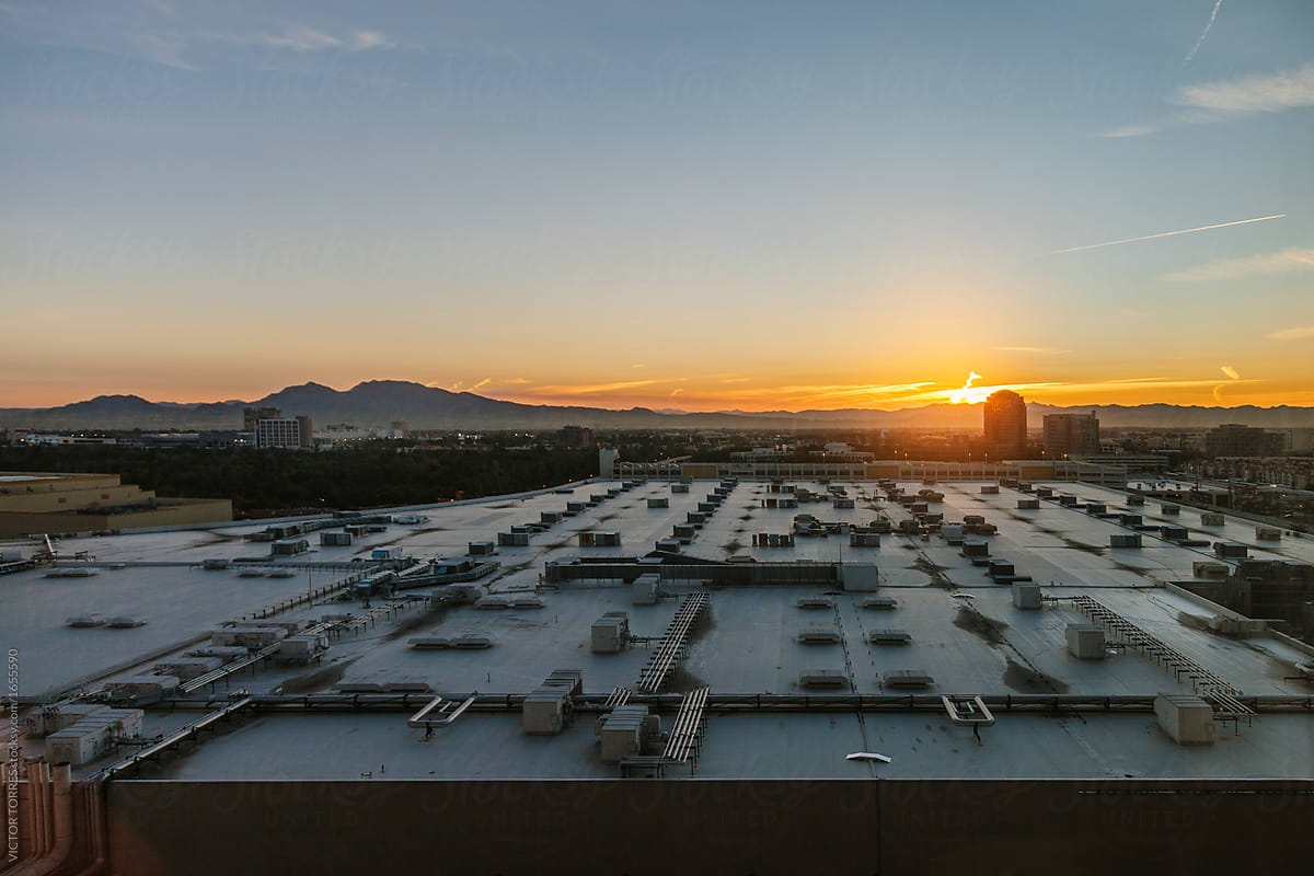 Sunset over a industrial roof with huge air conditioning system