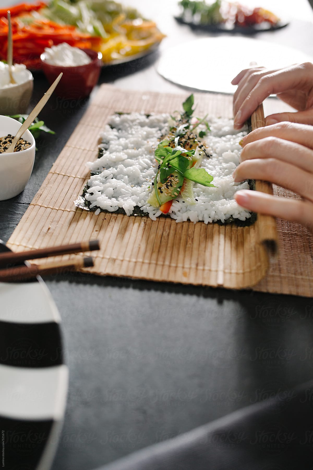 Woman Making Veggie Maki Sushi Rolls
