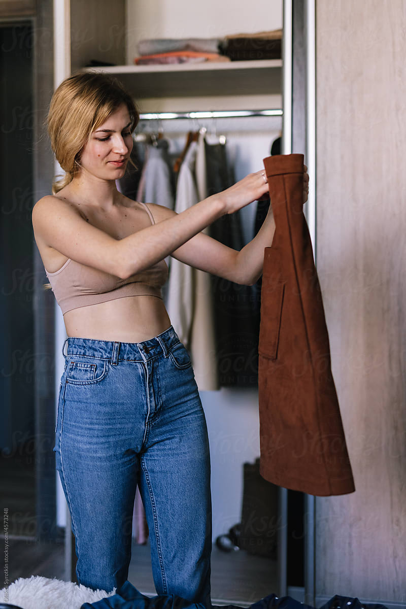 Woman organizing wardrobe at home