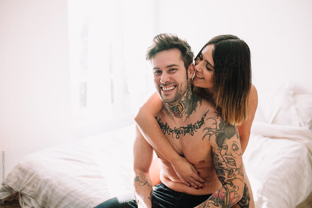 attractive couple caressing on bed in the morning by Thais Varela - Love, Valentine's day - Stocksy United
