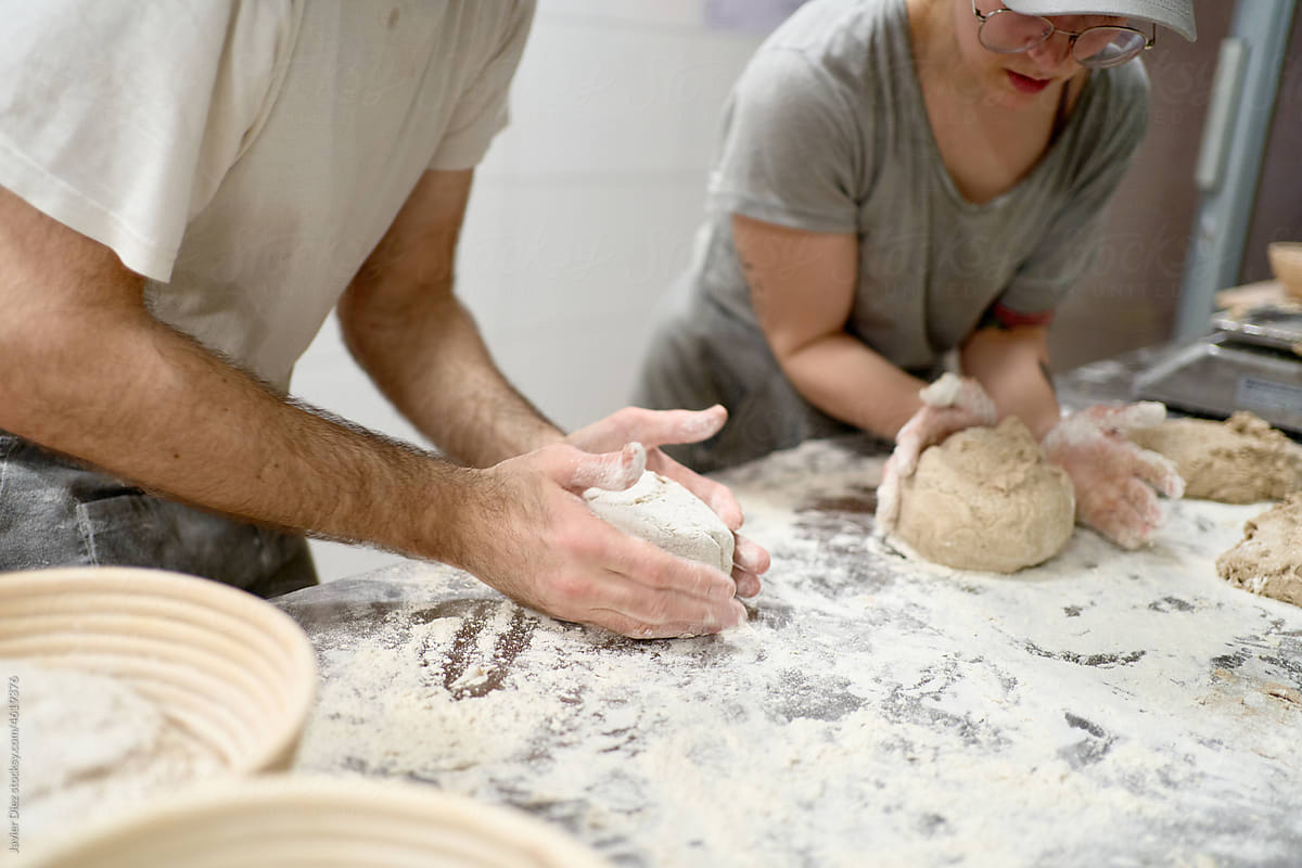 Bakers making bread in bakehouse