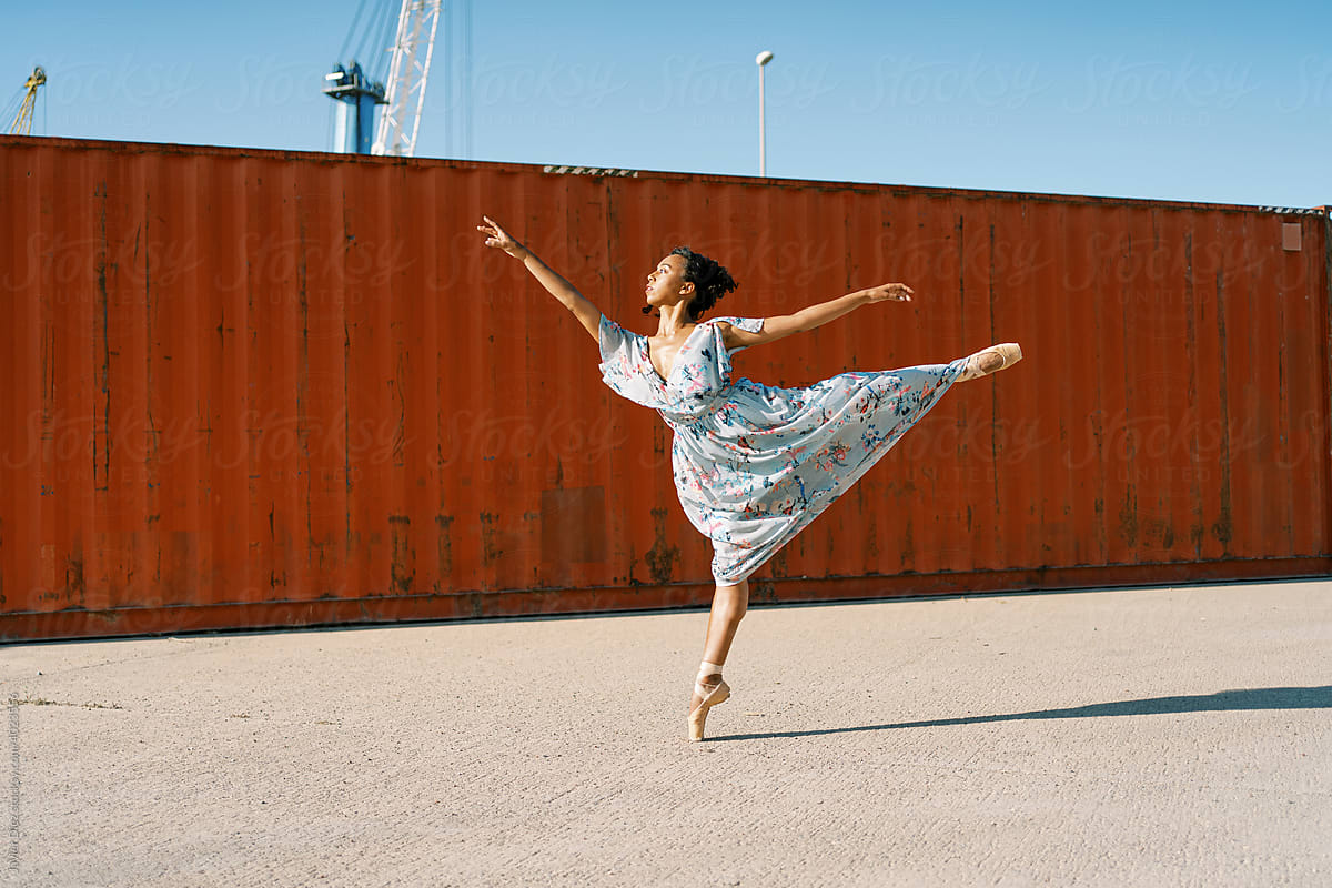 Elegant ballerina in summer dress dancing on tiptoe