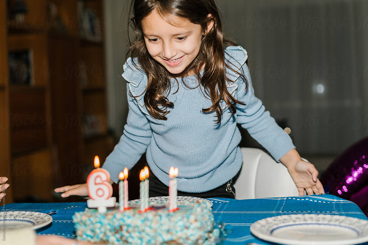 Child preparing to blow out candles