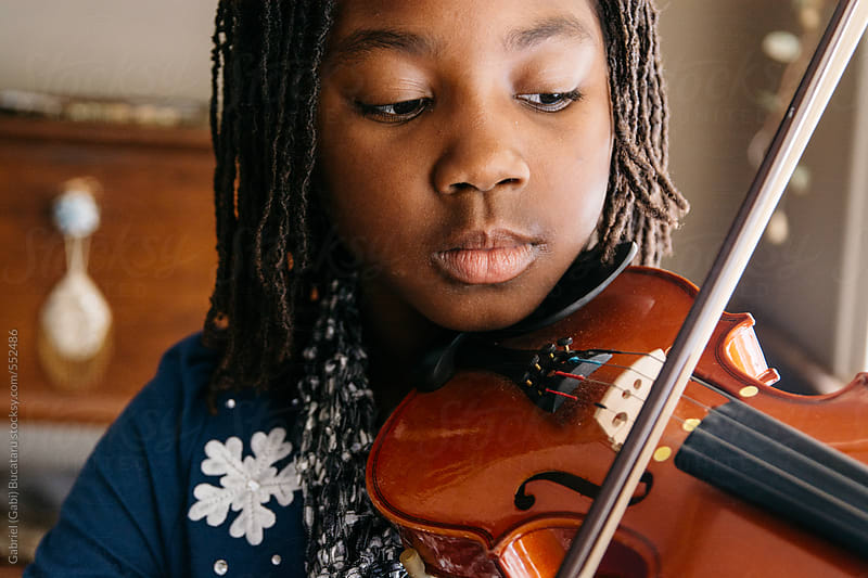 Black girl playing violin by <b>Gabriel (Gabi</b>) Bucataru for Stocksy United - 552486