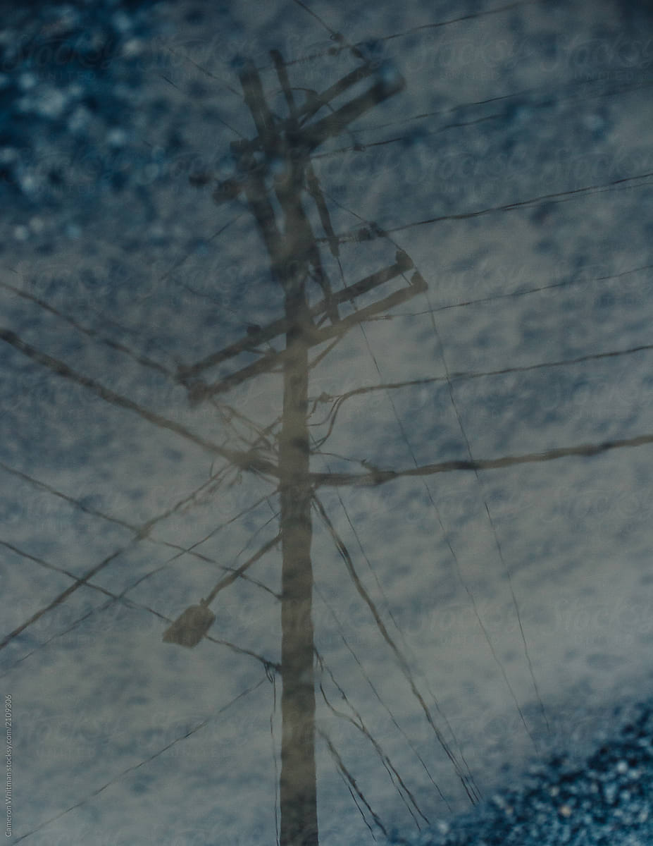 Power Lines Reflection In A Puddle