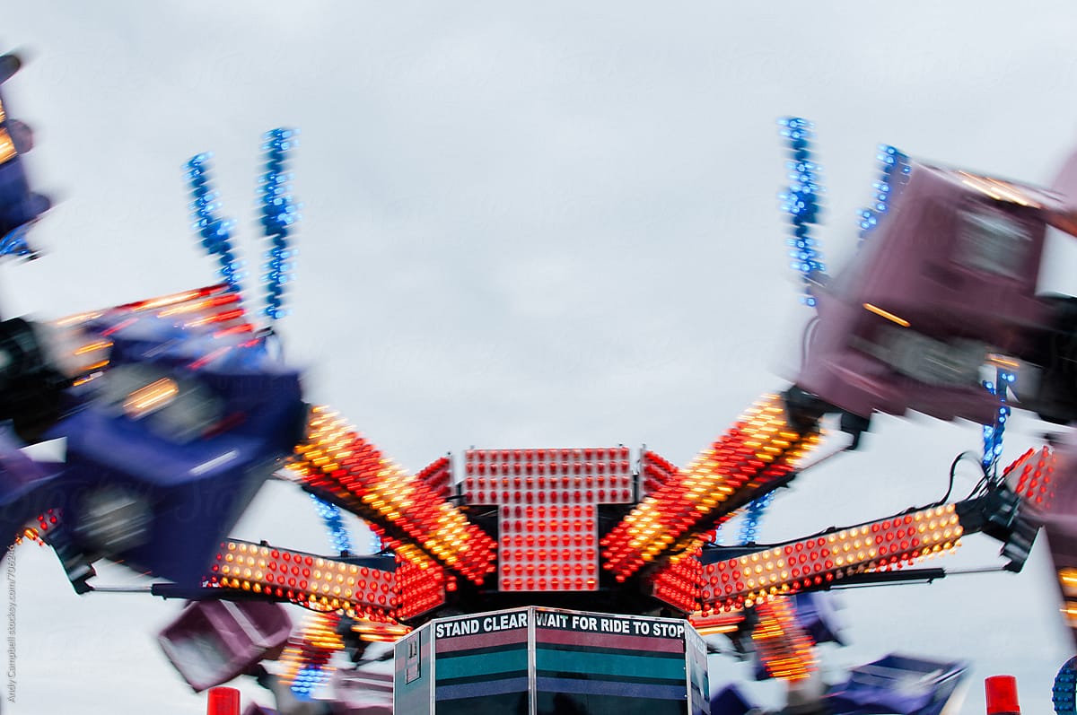 A carnival ride speeds past.