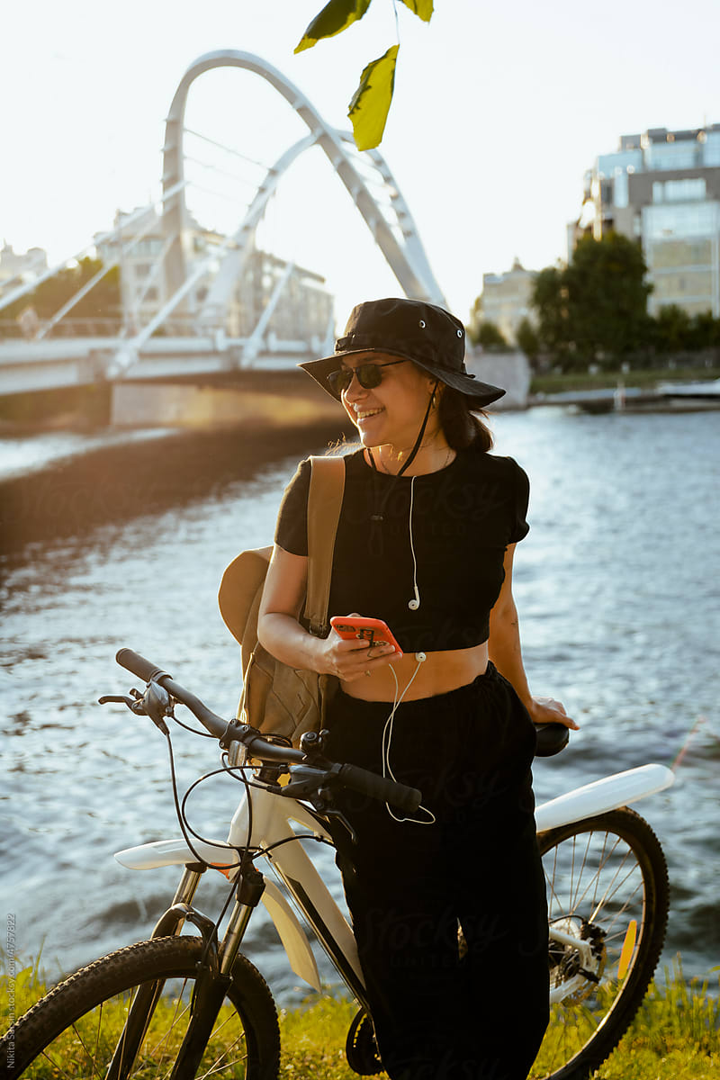 woman listening music while resting after riding