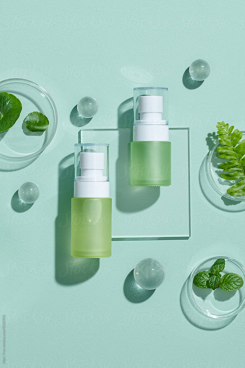 Cosmetic bottle containers with green herbal leaves Research