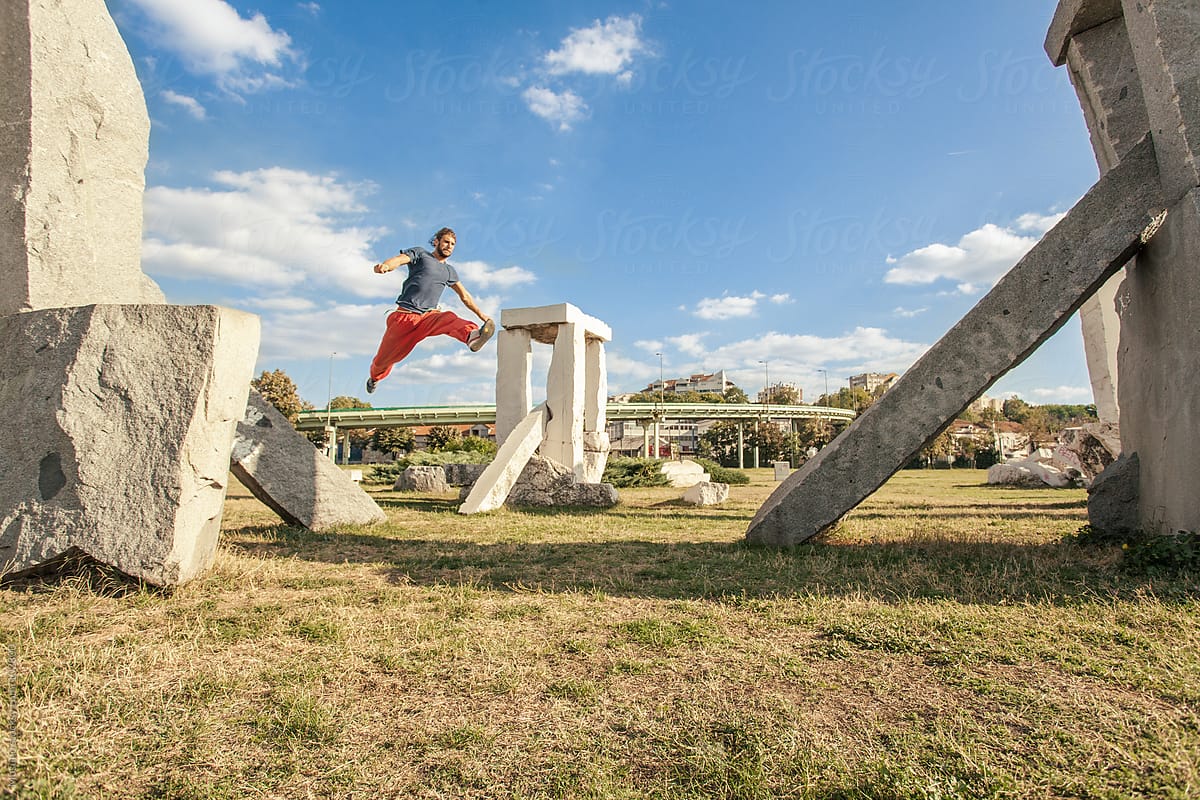 Man Practicing Parkour in the Park