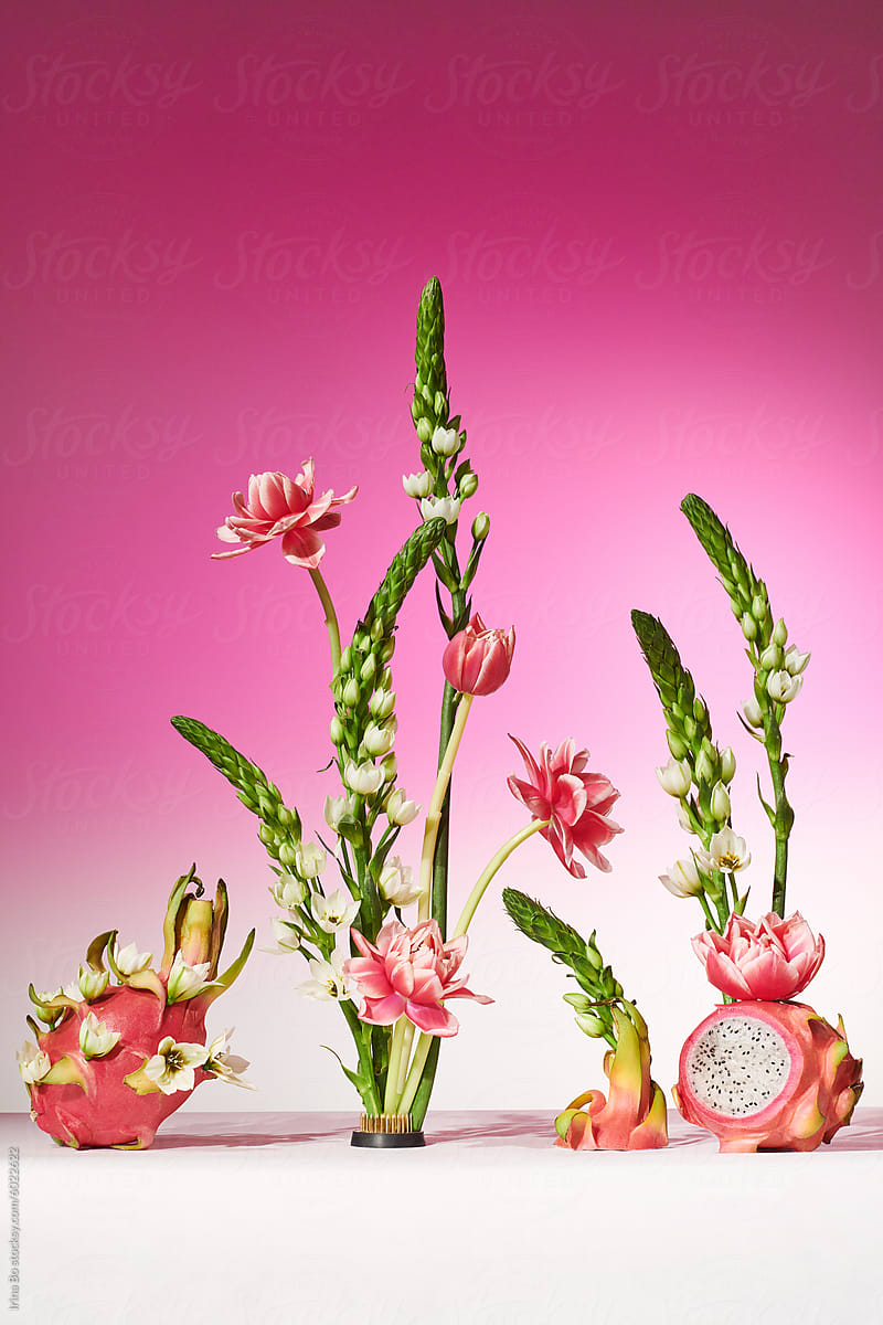 Bright composition of dragon fruit and flowers