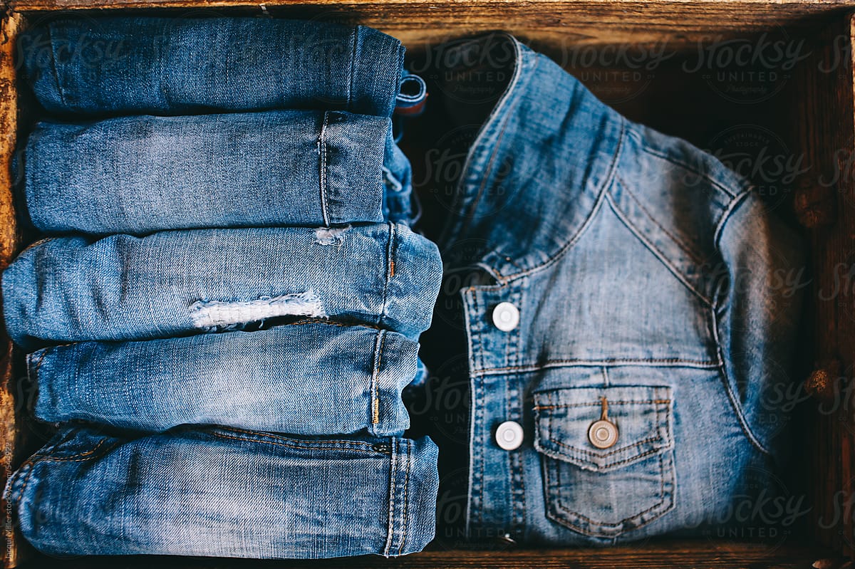 Selection of denim  clothing in wooden box