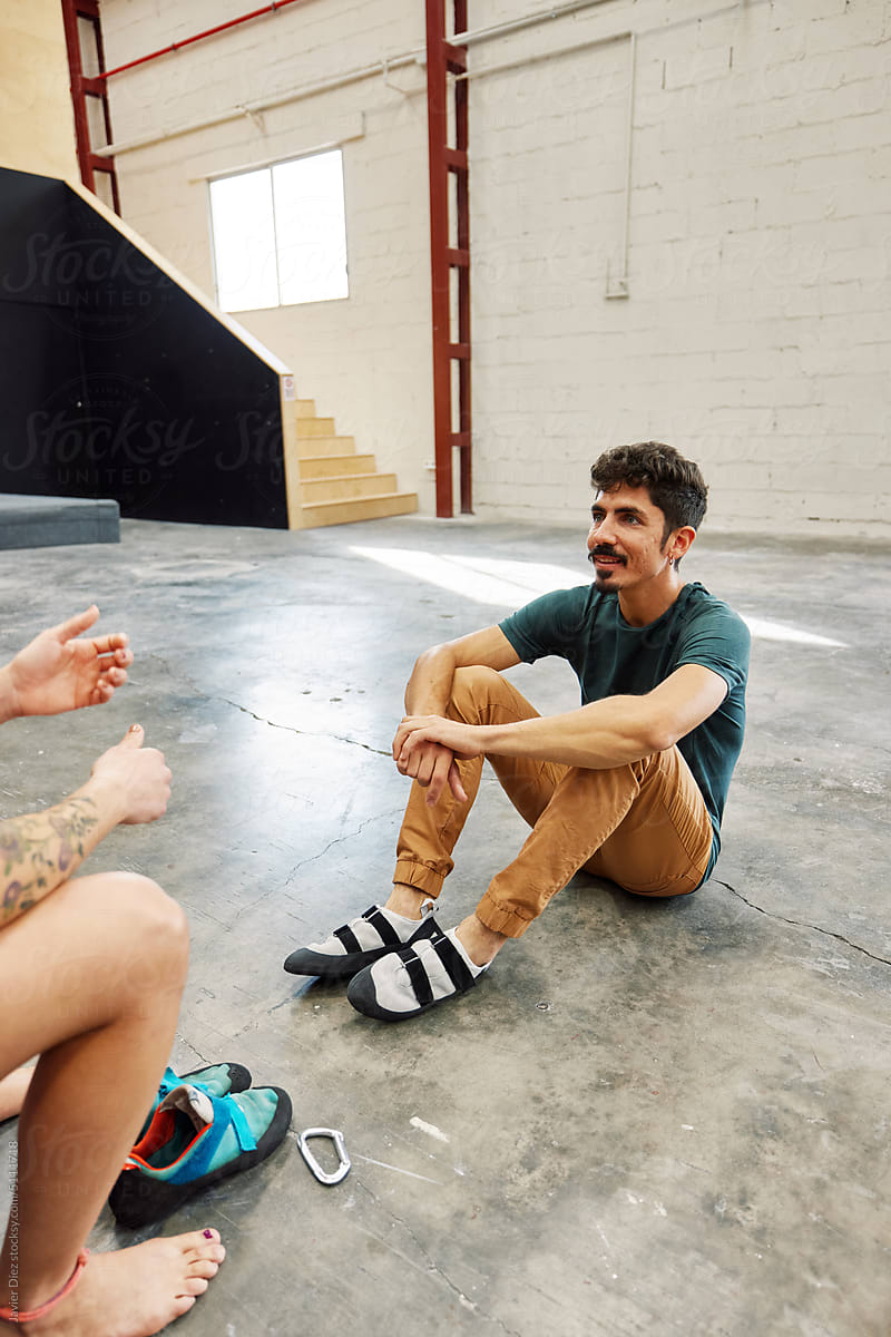 Climber couple speaking in bouldering gym