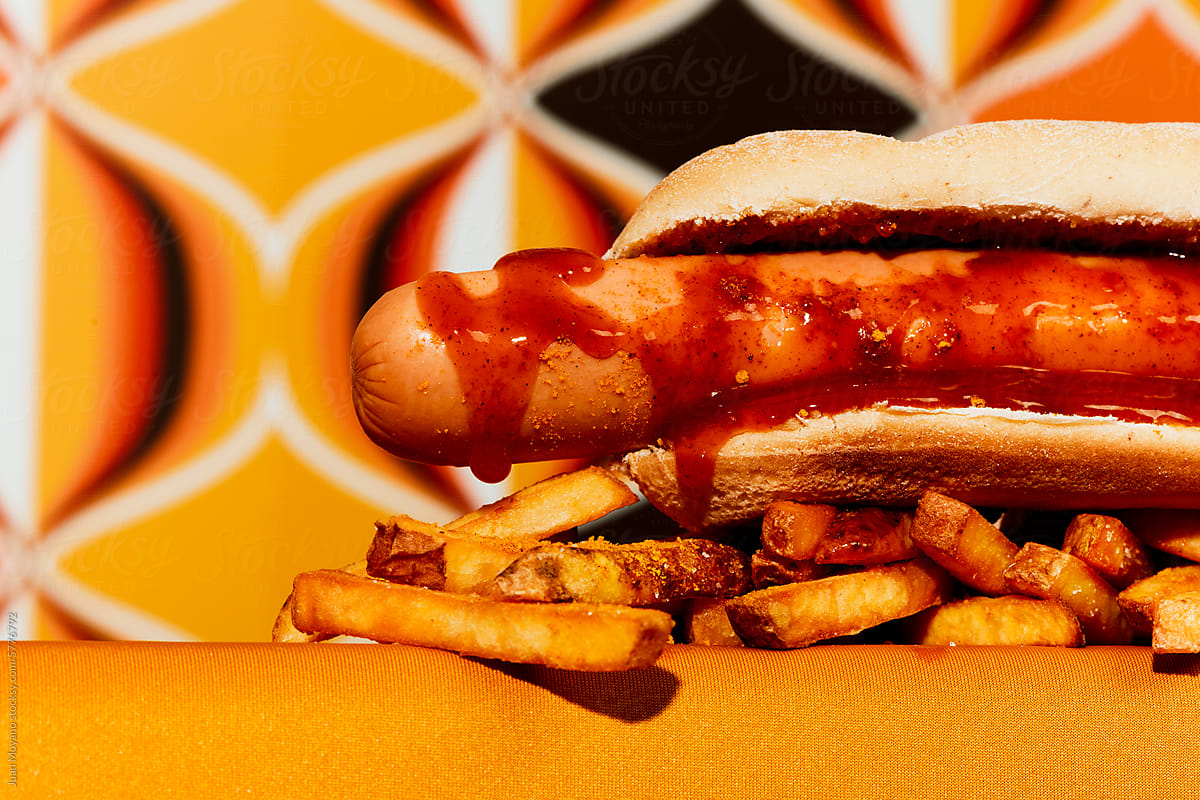 currywurst in a bun and french fries