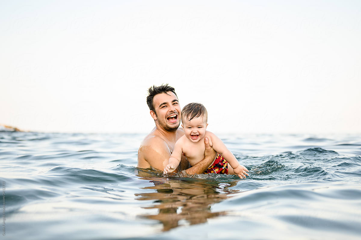 Father swimming with his son.