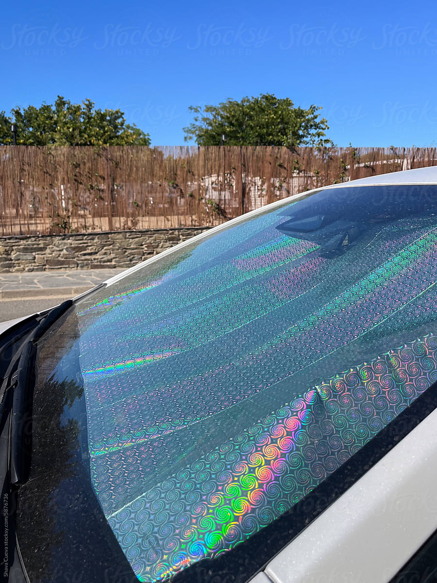 Car windscreen sun visor of metallic colors on the street