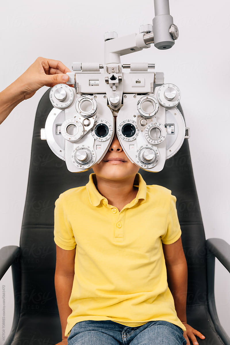 Unrecognizable boy in ophthalmological clinic checking vision