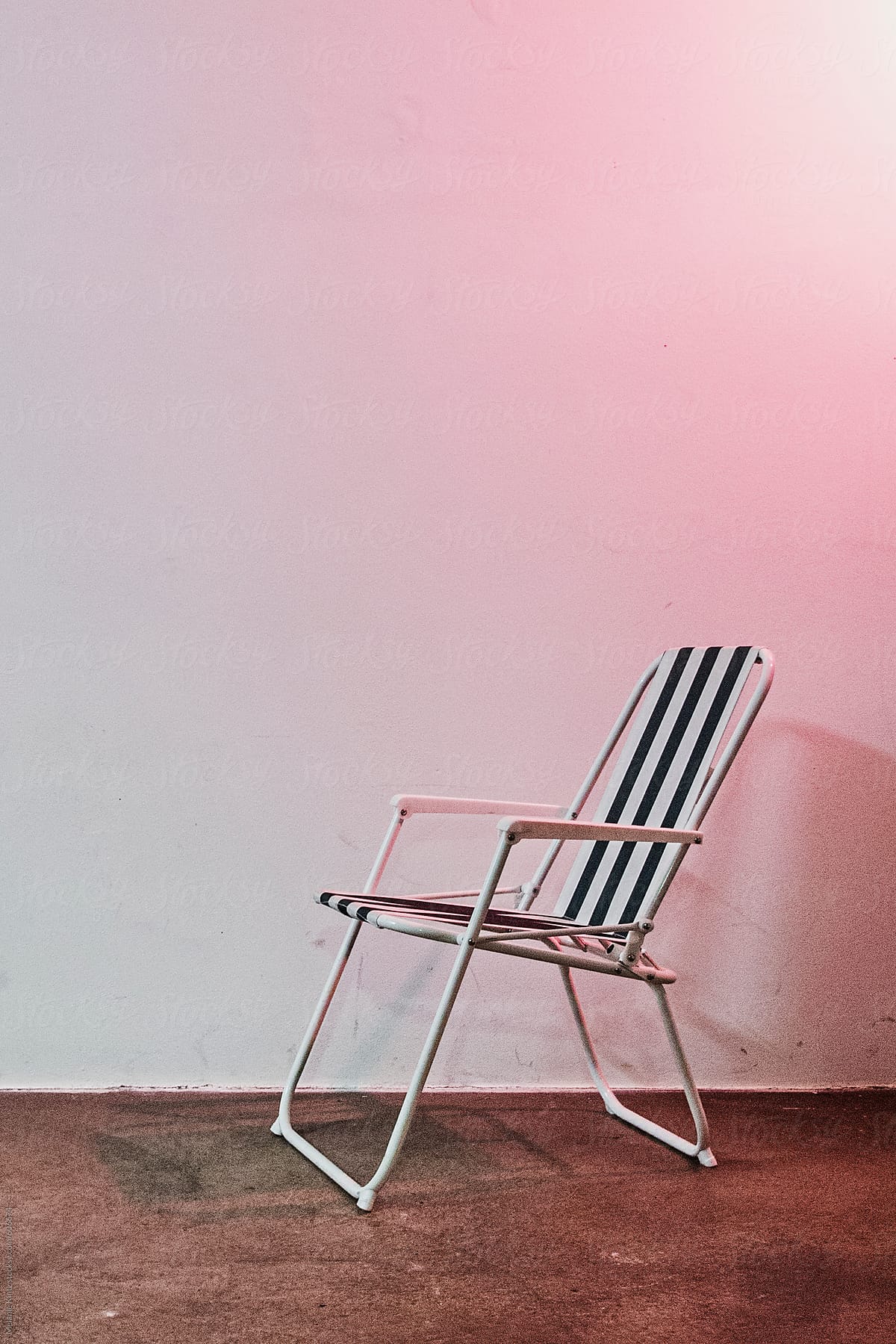 Beach chair in a room lit by a red 