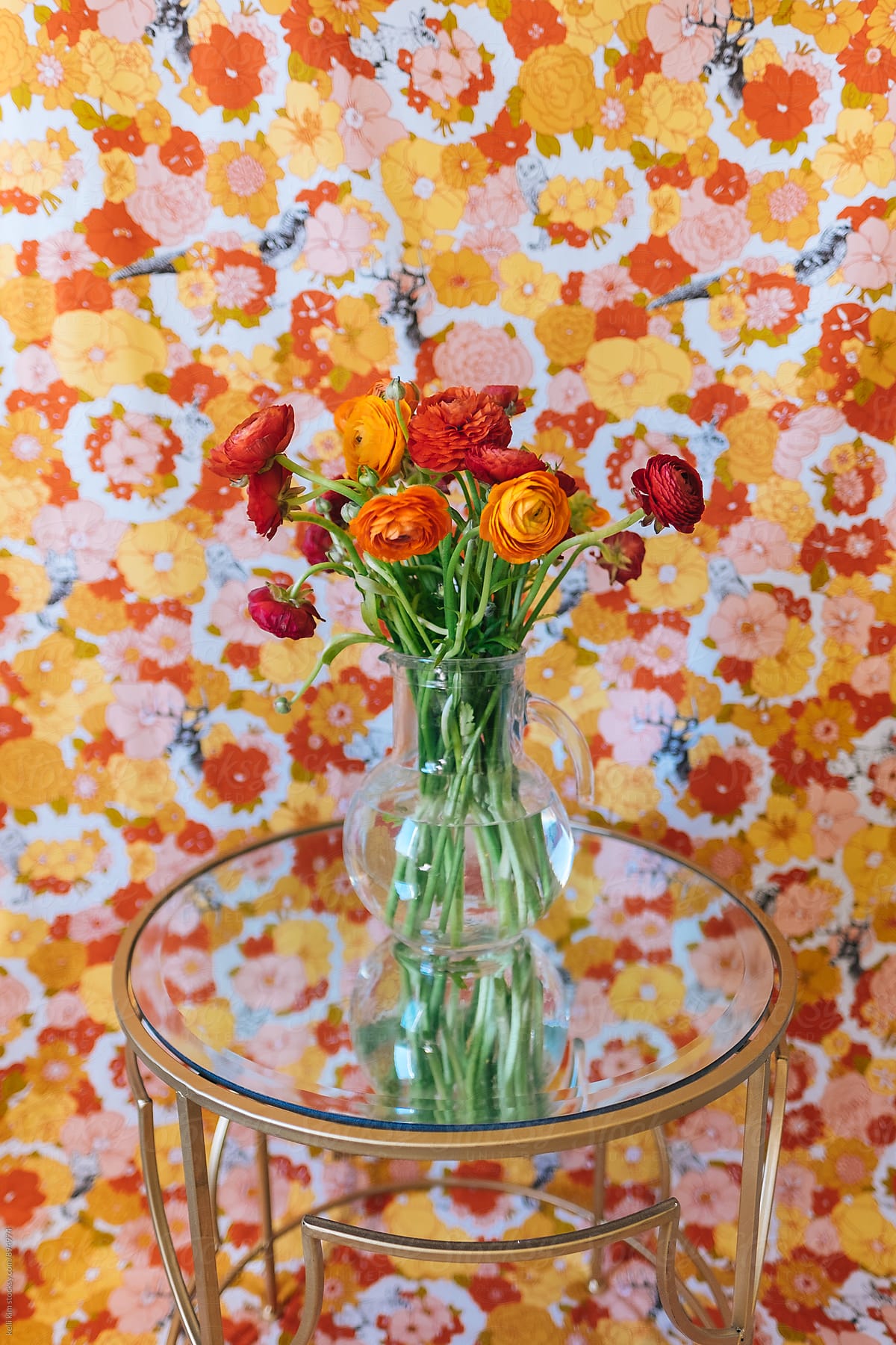 Bouquet of red and orange flowers on mirrored table