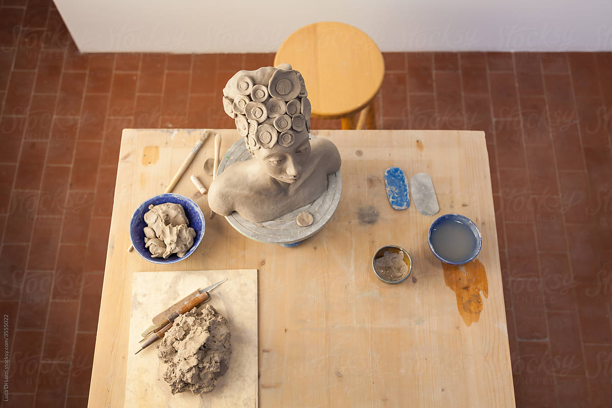 statue on a ceramist\'s workbench