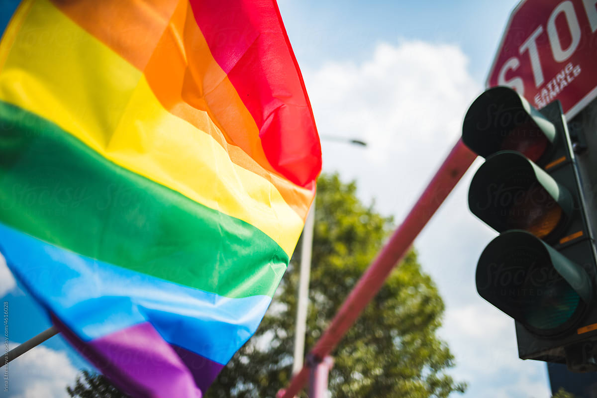 Pride flag waving at the street light
