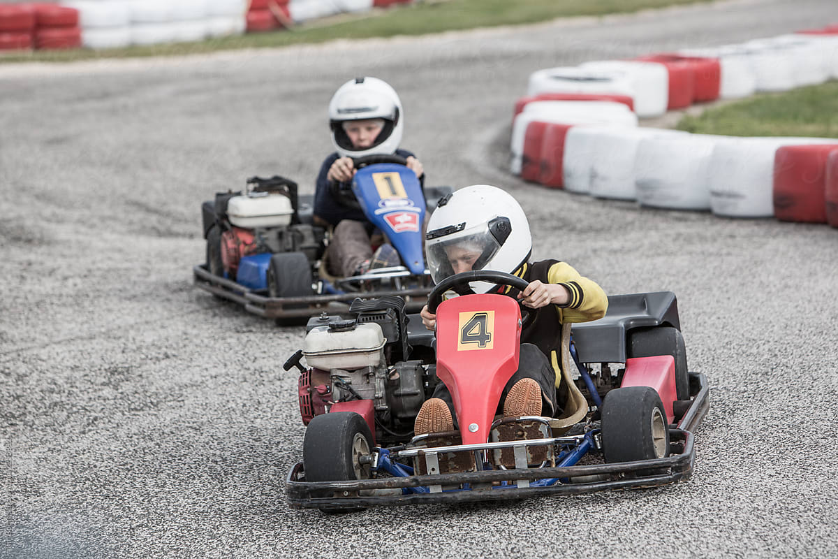 Two boys in a go-cart race.