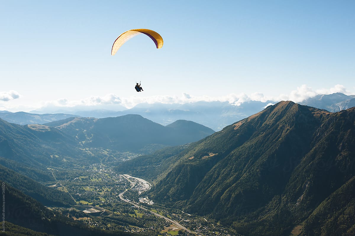 Man paragliding over mountains