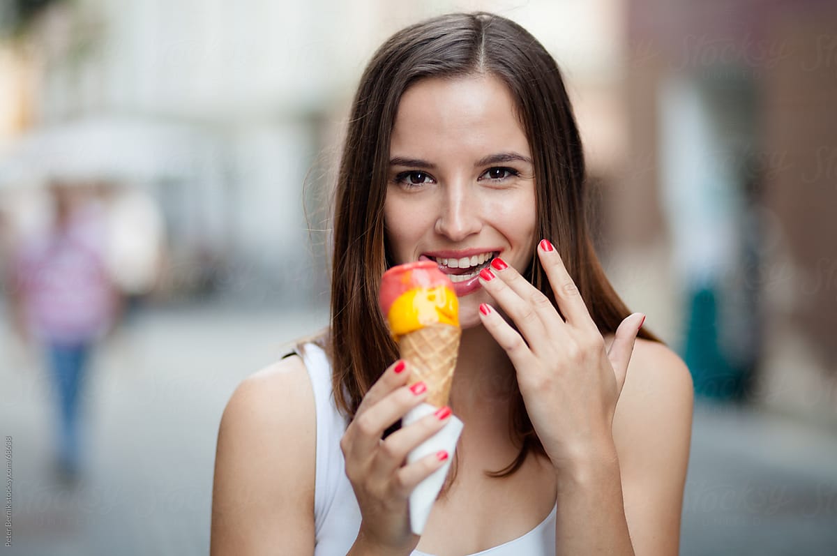Babe Woman Eating Ice Cream On The Street Stocksy United